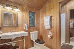 Upper level bathroom has two separate toilet vanity areas with a shared shower between